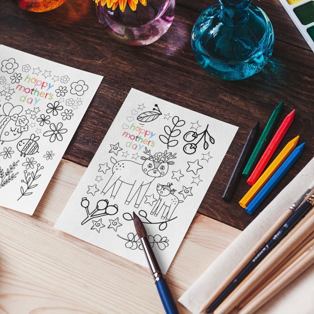 This image contains a Printable coloring busy book that open to pages with 'Happy Mother's Day' designs, featuring playful animals and hearts, available for download and print for kids and adults. The busy book is available uniquely at SharekknaOnline.com. It can be downloaded instantly and printed at home or your local print house. Numerous engaging and educational activities wait for parents and kids. From traditional coloring sessions with crayons, colored pencils, or markers to sparking imagination through storytelling based on the busy book's images, there's ample room for creativity.