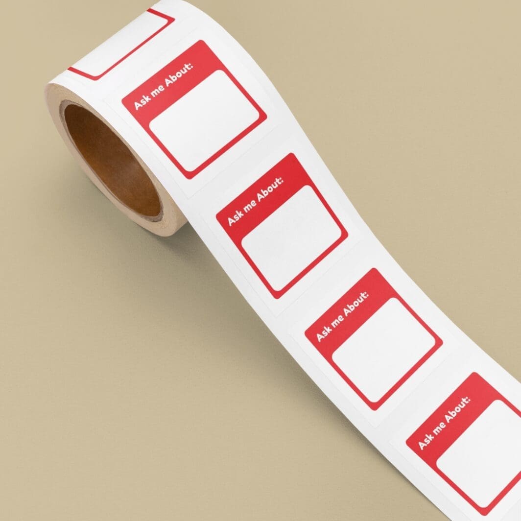 Colorful assortment of 72 Name and Identity Stickers displayed in a grid, each with a unique prompt like 'Call me...', 'I am from...', and 'Ask me about...', designed for use in meetings, workshops, and group settings.