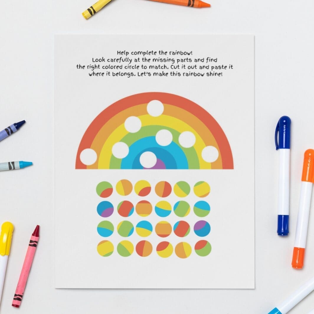Printable kids activity sheet featuring a half rainbow with missing colored circles and a grid of colorful circle pieces below for cutting and matching