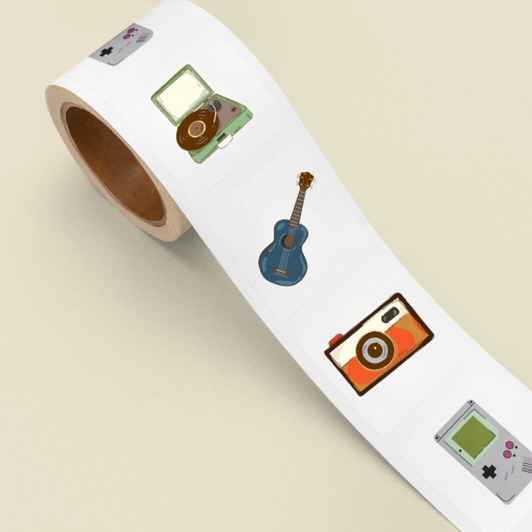 Digital sticker sheet titled Born in the 90’s featuring colorful retro illustrations, including a cassette tape, record player, guitar, scooter, vintage phones, sunglasses, Game Boy, slinky, Rubik’s Cube, old TV, camera, floppy disk, and denim pants on a beige background