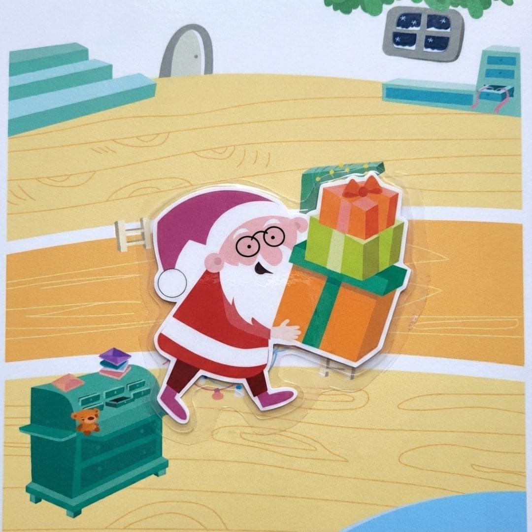 Build Santa’s Workshop printable Christmas activity sheet showing Santa and elves working together in a festive workshop, with toys, decorations, Christmas tree, gifts, and cozy holiday details in a colorful illustrated scene