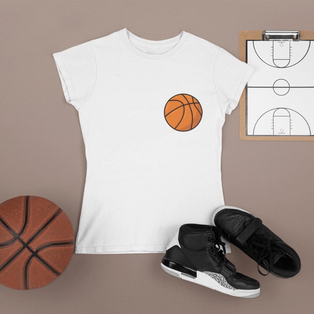 Create a realistic video based on the provided image of a white t-shirt with a basketball design, placed on a neutral background with basketball accessories (ball, shoes, clipboard). Scene starts with the same exact composition and camera angle (top-down view). The basketball design on the t-shirt should initially appear slightly faded or semi-transparent. A woman’s hand (natural skin tone, clean nails, no distracting accessories) enters the frame smoothly from the side holding the basketball sticker (use the EXACT provided sticker design — do not modify, redraw, or change colors, shape, or style). She carefully places the sticker onto the t-shirt in the exact position shown. Then simulate a realistic sublimation / heat transfer process: The hand gently presses the sticker onto the fabric Add a subtle glowing or heat effect (very soft, not exaggerated) The sticker gradually blends into the fabric texture The design becomes fully vibrant, sharp, and embedded into the shirt (not looking like a separate sticker anymore) Add slight fabric interaction (small wrinkles or pressure effect) for realism. Lighting: soft studio lighting, clean shadows Style: photorealistic product video Camera: fixed top-down shot, no camera movement Duration: 5–8 seconds Focus: smooth, satisfying transformation effect End result: the basketball design looks perfectly printed on the shirt as part of the fabric.