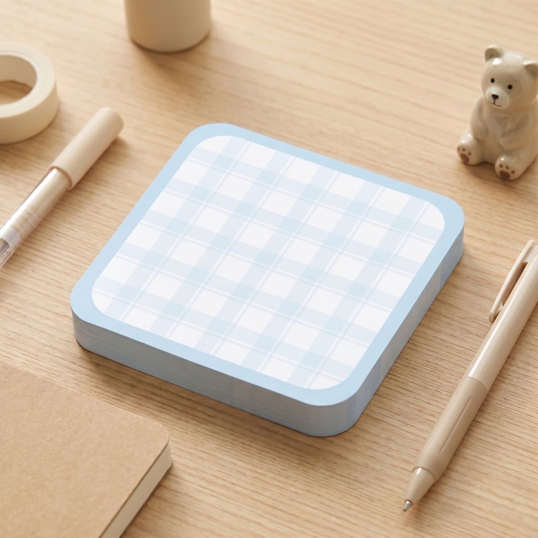 Pastel blue minimalist memo notes bundle featuring cute to-do list layouts, grid memo pages, floral doodles, and cozy Korean-inspired printable stationery designs arranged as aesthetic memo pads on a wooden desk.